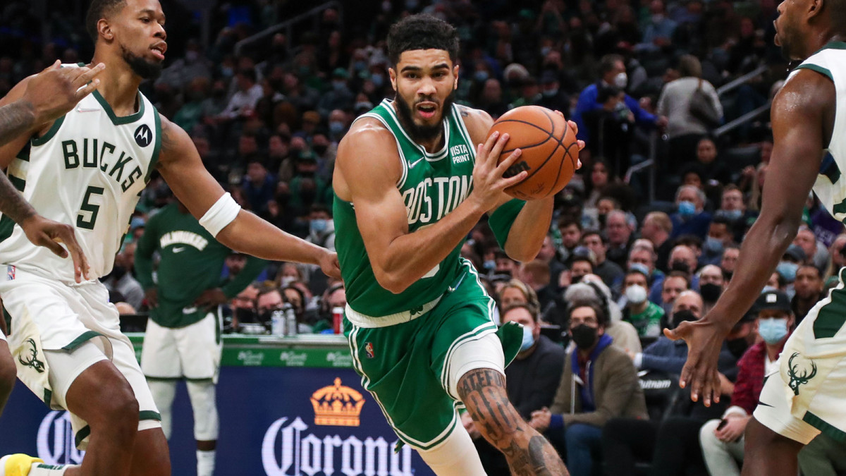 Boston Celtics forward Jayson Tatum (0) drives to the basket while defended by Milwaukee Bucks forward Rodney Hood.